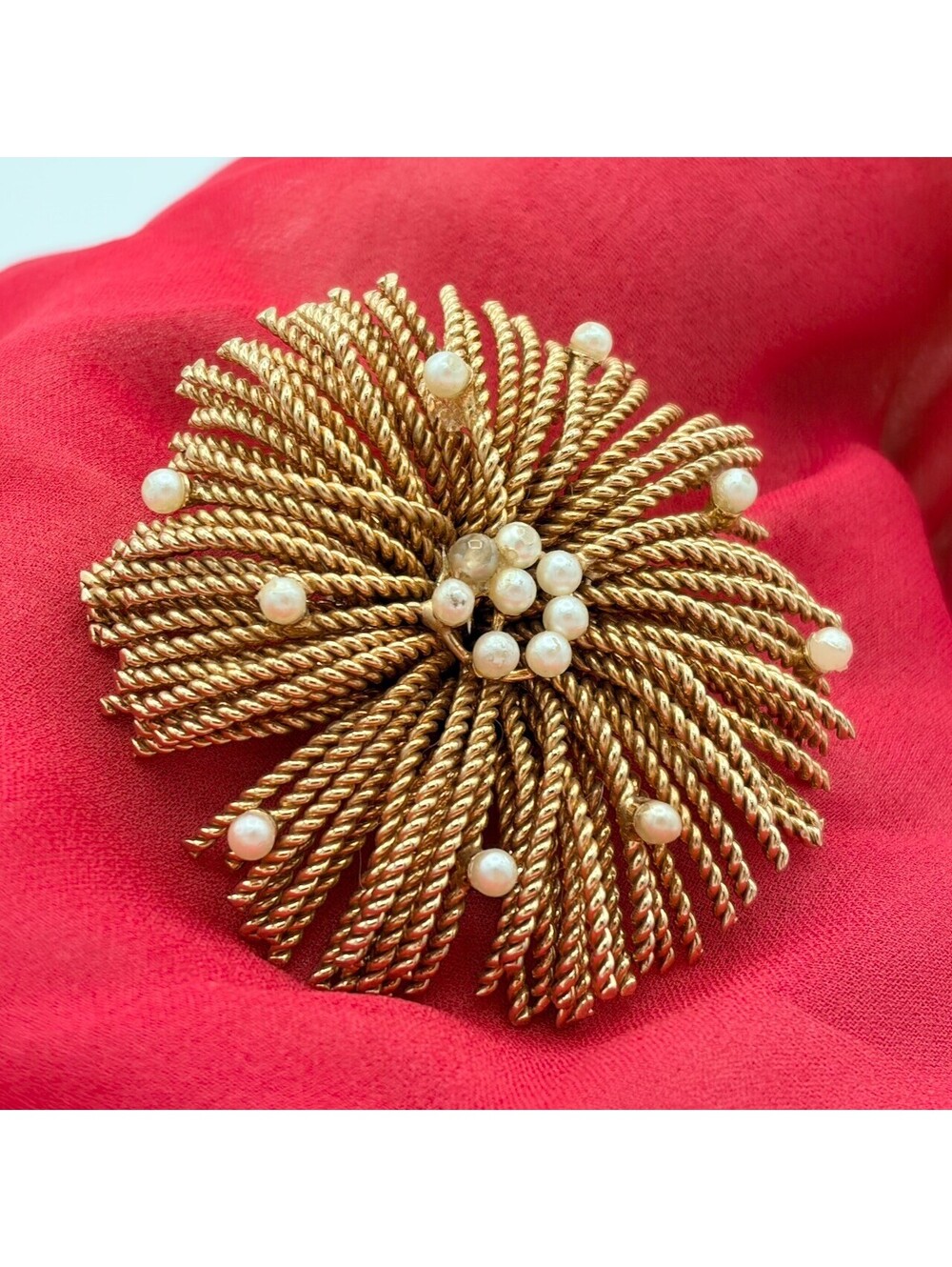 Vintage piece is a gold-tone unsigned Bergere starburst fireworks brooch
